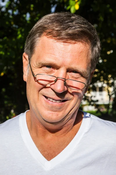 Happy attractive man in the garden — Stock Photo, Image