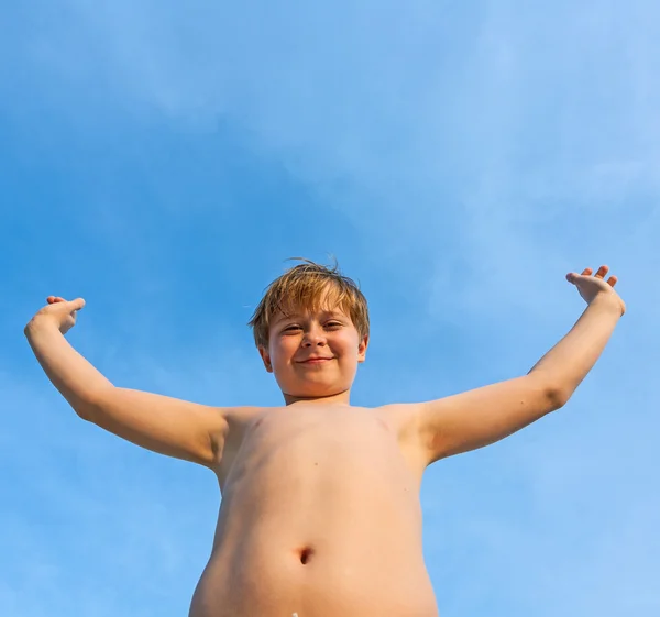 Happy smiling young boy with background blue sky — Stock Photo, Image