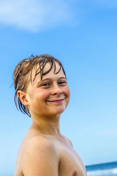 Mignon garçon avec les cheveux mouillés à la plage — Photo