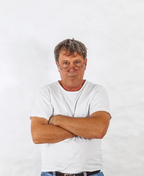 Portrait of a smart casual man smiling with hands folded — Stock Photo, Image