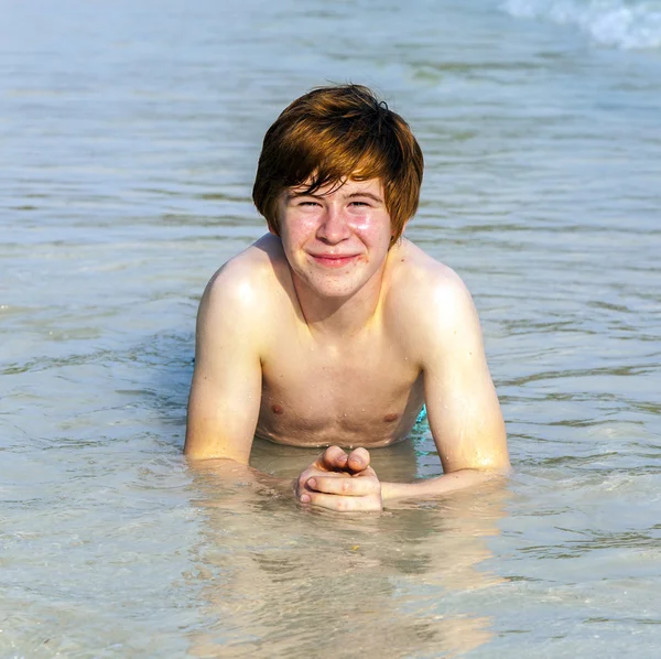 Cute boy lies at the beach Stock Picture