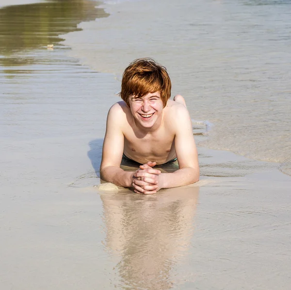 Cute boy lies at the beach Stock Image