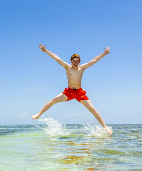 Brothers in a swim ring have fun in the ocean — Stock Photo, Image