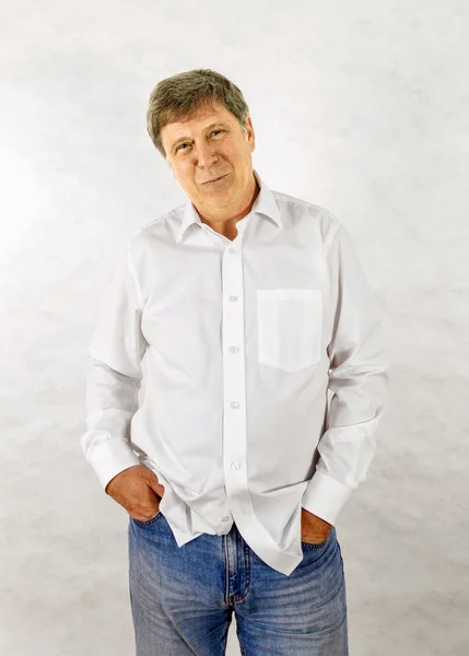 Happy senior man standing gesturing against white background — Stock Photo, Image