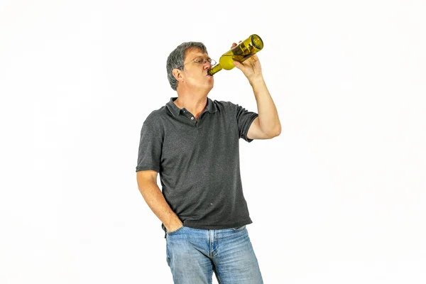 Man drinks alcohol out of a bottle — Stock Photo, Image