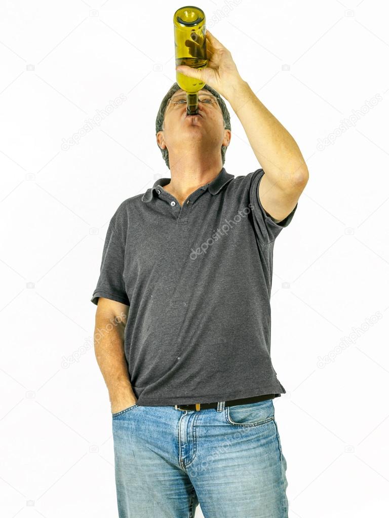 man drinks alcohol out of a bottle