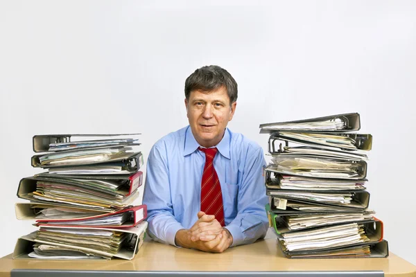 Man studies map met bestanden achter zijn Bureau in het kantoor — Stockfoto