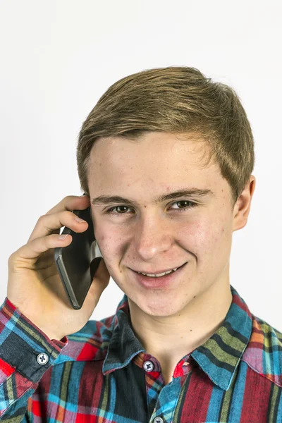 Teenage boy uses the mobile — Stock Photo, Image