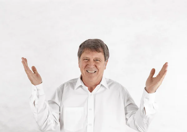 Happy senior man standing gesturing against white background — Stock Photo, Image