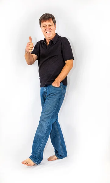 Portrait of attractive casual man in studio showing thumbs up — Stock Photo, Image