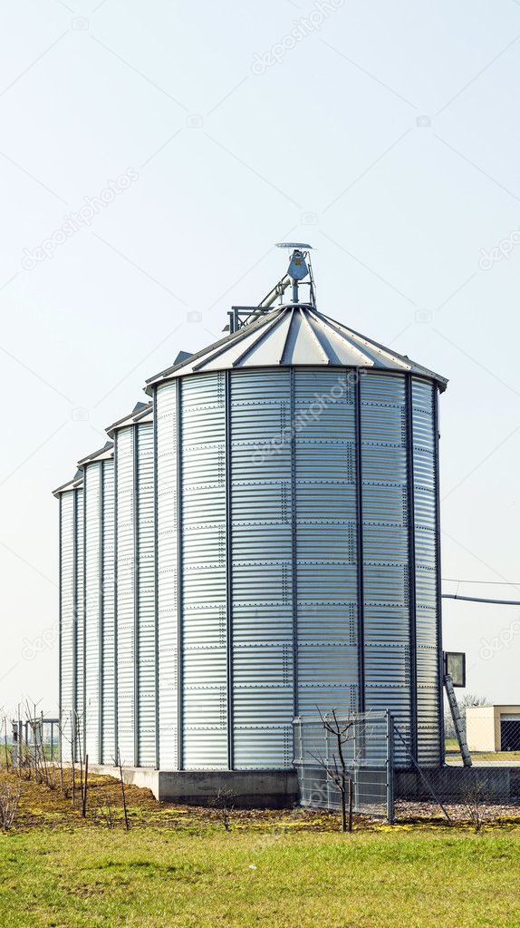 silver silos in field 