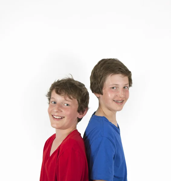 Teenage brothers in red and blue shirt hugging and posing Royalty Free Stock Images