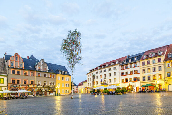 people enjoy sunset at central market place in Weimar