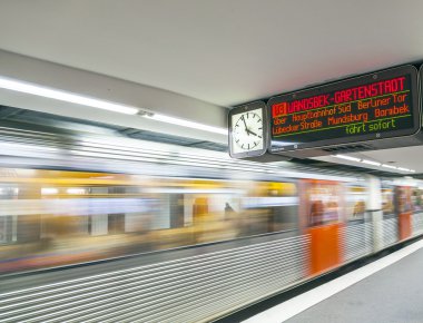 people in the metro station with train in motion clipart