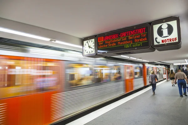 people in the metro station with train in motion