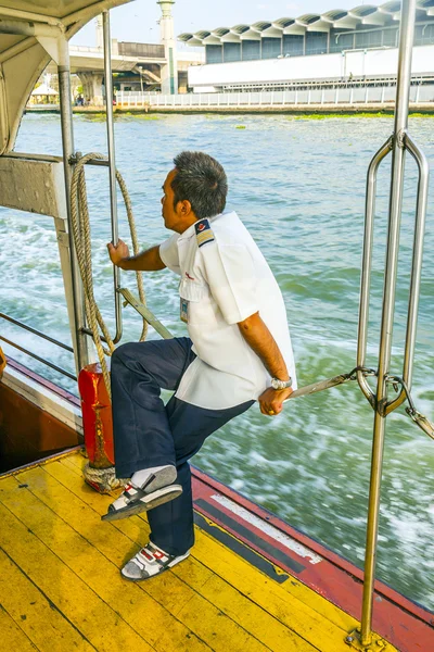 Captain sitting on the safety chain of the ferry — Stock Photo, Image