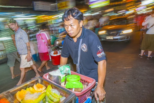 Unidentified owner of streetside rolling food stall — Stock Photo, Image