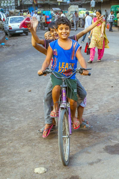 Children sitting on a bike early morning — Stock Photo, Image