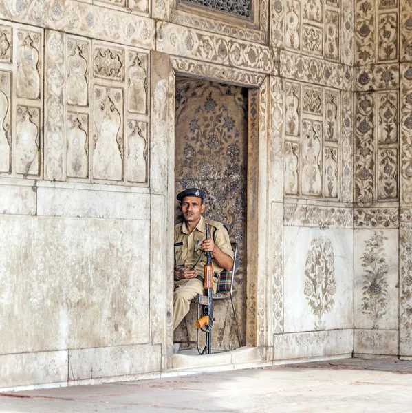 policeman pays attention in the Red Fort to protects visitors fr