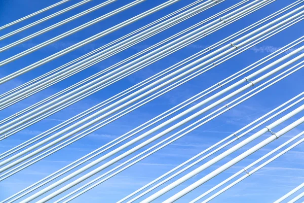 Pattern of steel wires of a bridge under blue sky — Stock Photo, Image