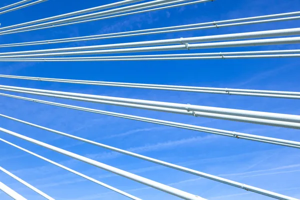 Pattern of steel wires of a bridge under blue sky — Stock Photo, Image