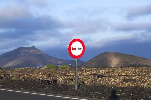 Landscape with a traffic sign: Don't overtake — Stock Photo, Image