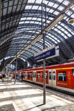 travelers inside the Frankfurt central station heading or leavin clipart