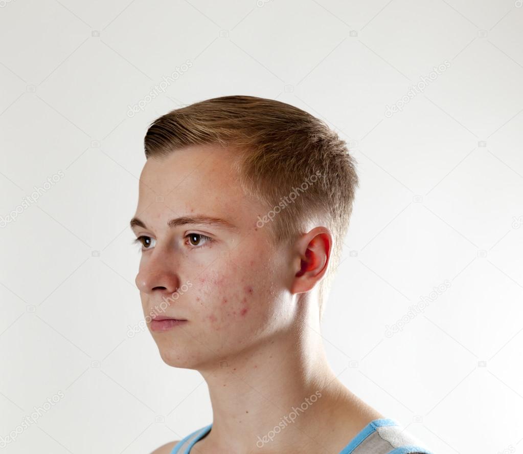 Portrait of a positive adolescent boy in puberty 