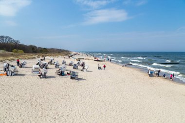 Zempin, Almanya - 20 Nisan 2014: İnsanlar Koserow 'un Usedom kentindeki çatıdaki Wickerd sandalyelerinde güneşin tadını çıkarıyorlar.