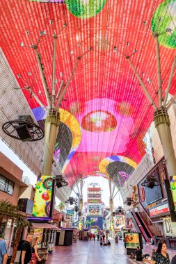 Las Vegas, USA - May 24, 2022: Hustle and bustle of crowds during the day on the famous Fremont Street in the heart of downtown Las Vegas with its Casinos, Neon Lights and Street Entertainment.