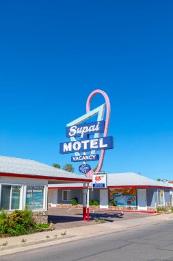 Seligman, USA - May 25, 2022: Motel and Route 66 sign Supai on Historic Route 66. Built in 1904. The neon light lost color but is still in use.