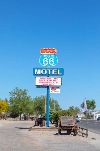 Seligman, USA - May 25, 2022: Motel and Route 66 sign  on Historic Route 66. Built in 1904. The neon light lost color but is still in use.