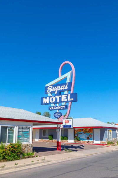 Seligman, USA - May 25, 2022: Motel and Route 66 sign Supai on Historic Route 66. Built in 1904. The neon light lost color but is still in use.