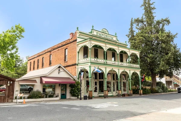 Jamestown, USA - June 3, 2022: old historic building Emporium from 1897 with typical 2 storage  architecture  and wooden facade with balcony in Jamestown, California.