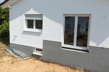detail of facade of construction site with grey socket,closed window and isolation issues