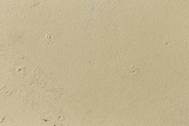 pattern of ochre painted old wall with irregularities