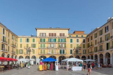 Palma, Spain - June 22, 2022: facade of old buildings at central historic market square in sunset.