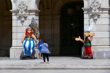 La Coruna, İspanya - 2 Eylül 2021: İnsanlar La Coruna 'daki tarihi belediye binasının girişinde Asterix ve Oburiks' in fotoğraflarını çekmekten zevk alıyorlar..