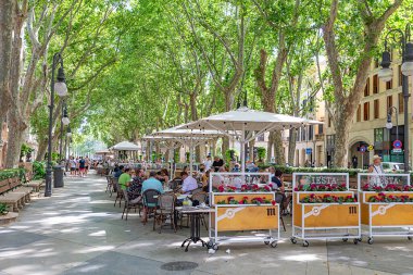 Palma de Mallorca, Spain - June 22, 2022: entrance of La Rambla with tourists and locals walking. this is a popular pedestrian area 1.2 kilometer-long