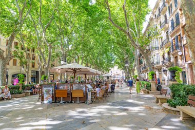 Palma de Mallorca, Spain - June 22, 2022: entrance of La Rambla with tourists and locals walking. this is a popular pedestrian area 1.2 kilometer-long