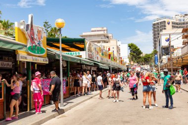 Palma de Mallorca, Spain - June 22, 2022: people have party at the Schinkenstrasse, engl: Ham Street at Ballermann - engl: fun man in Palma.