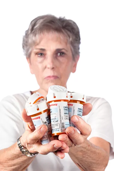 Elderly woman with medication — Stock Photo, Image