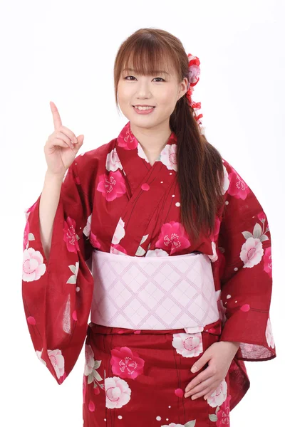Young asian woman in kimono pointing up — Stock Photo, Image