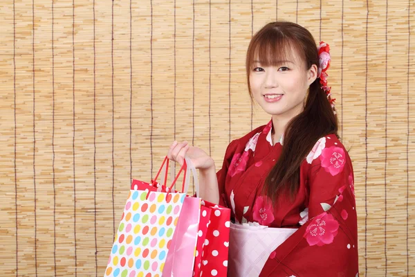 Young asian woman with shopping bags — Stock Photo, Image