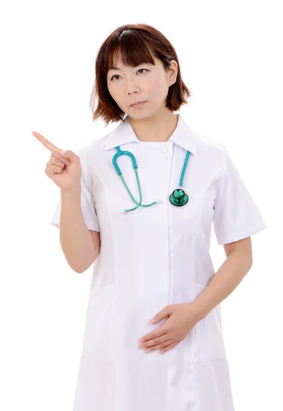 Young asian female nurse pointing — Stock Photo, Image