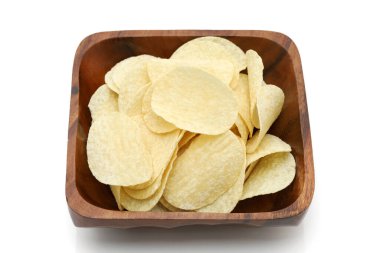 Potato chips in wooden bowl on white background, Close up.