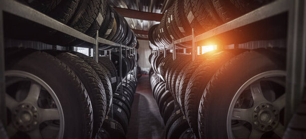 tire at repairing service garage background. Car tire in warehouse. Transportation and automotive maintenance concept