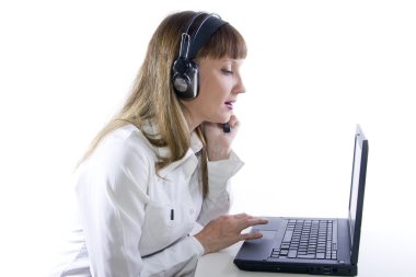 vrouw met hoofdtelefoon die op laptop werkt