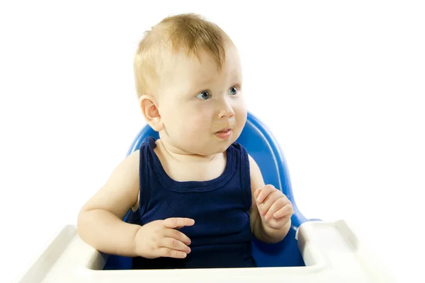 A young gray-eyed child feeding porridge — Stock Photo, Image