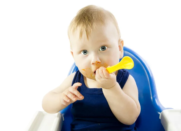 Gray-eyed child feeding spoon pumpkin puree — Stock Photo, Image